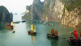 Travelers with Halong Bay on a traditional junk